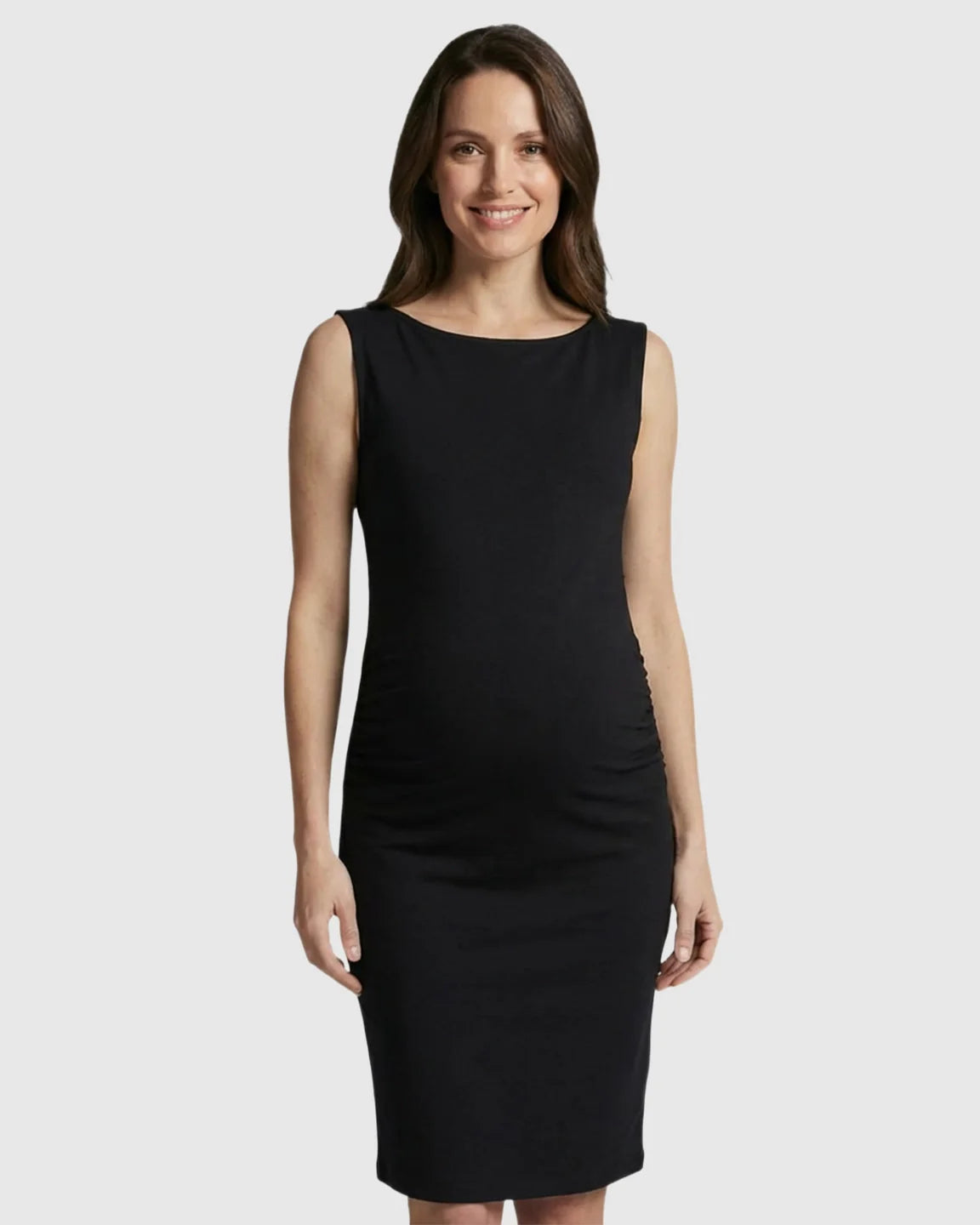 Smiling pregnant woman in a black sleeveless bodycon maternity midi dress with side ruching.