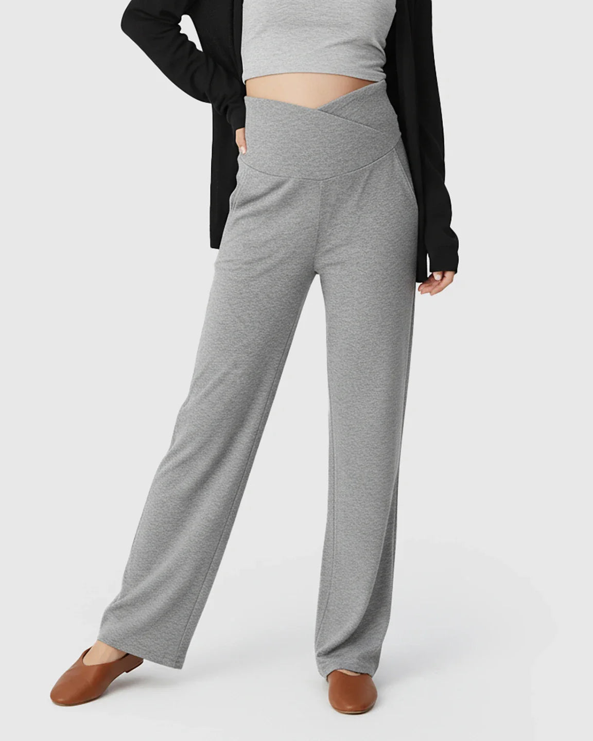 Gray wide-leg maternity lounge pants with a crossover waist, styled with a crop top and cardigan.