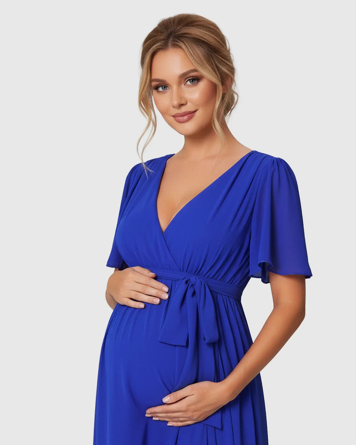 Maternity maxi dress in royal blue with surplice V-neck, flutter sleeves, and adjustable empire waist tie.