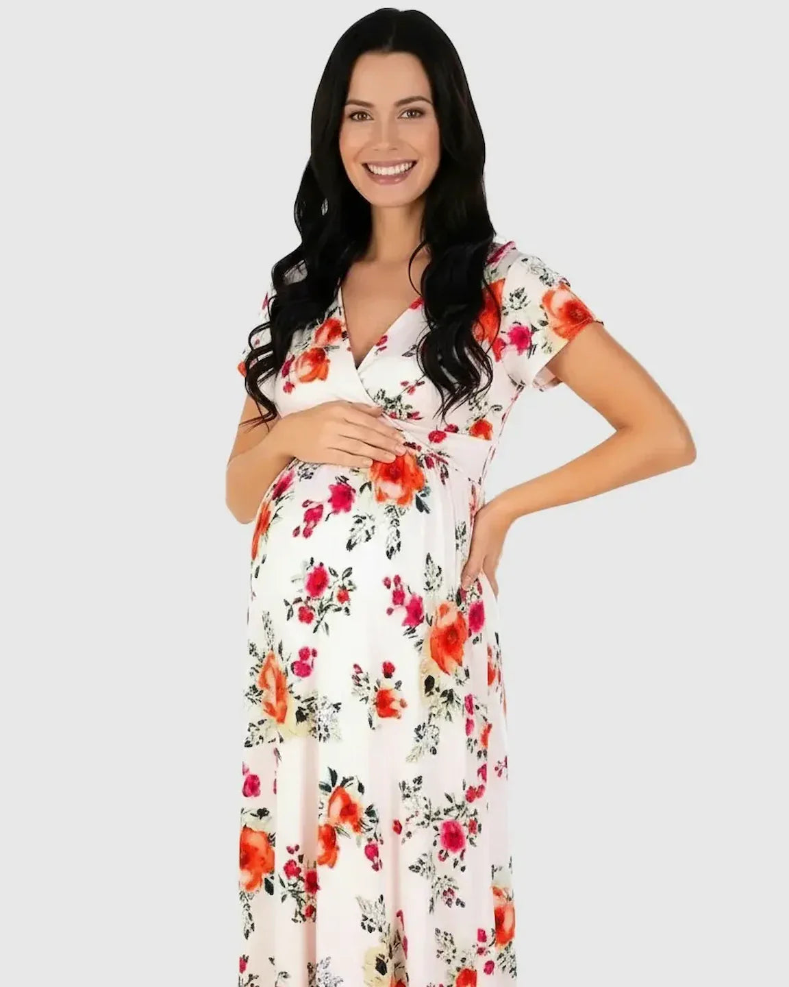 Smiling pregnant woman in a white floral V-neck short sleeve maternity maxi dress.