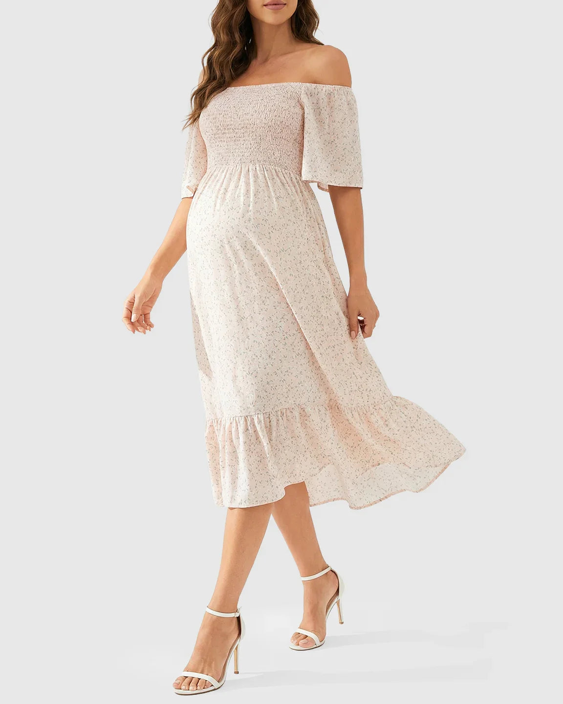 Light pink floral off-shoulder smocked maternity midi dress with flutter sleeves and tiered skirt.