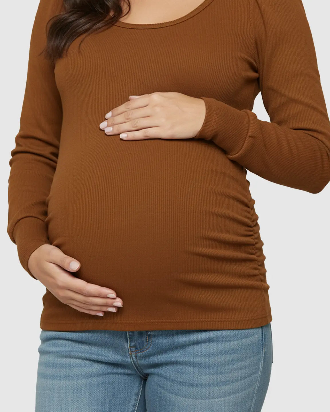 Brown ribbed long-sleeve maternity top with side ruching, worn by a pregnant woman.