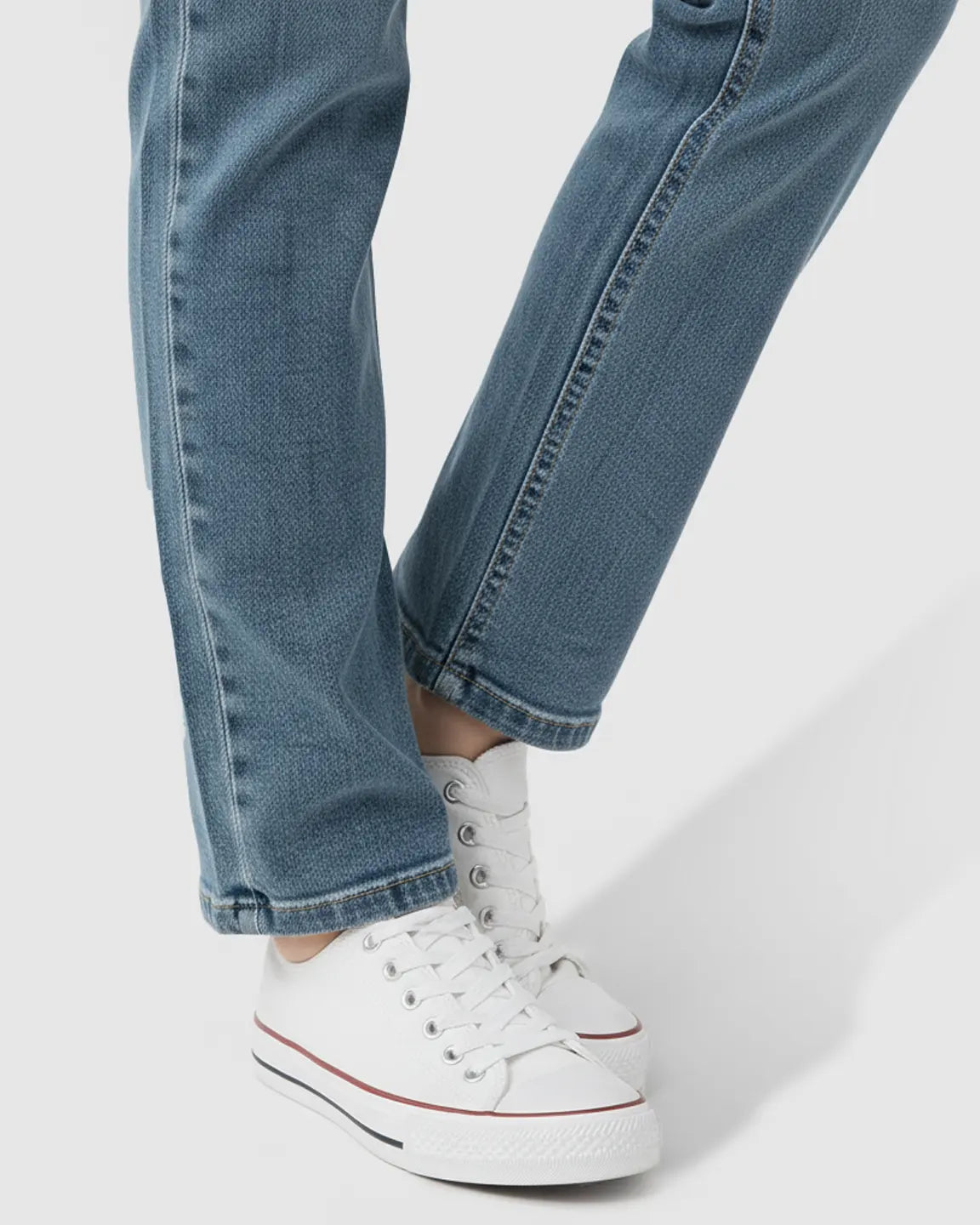 Light wash blue straight-leg maternity jeans with side panels, paired with white sneakers.