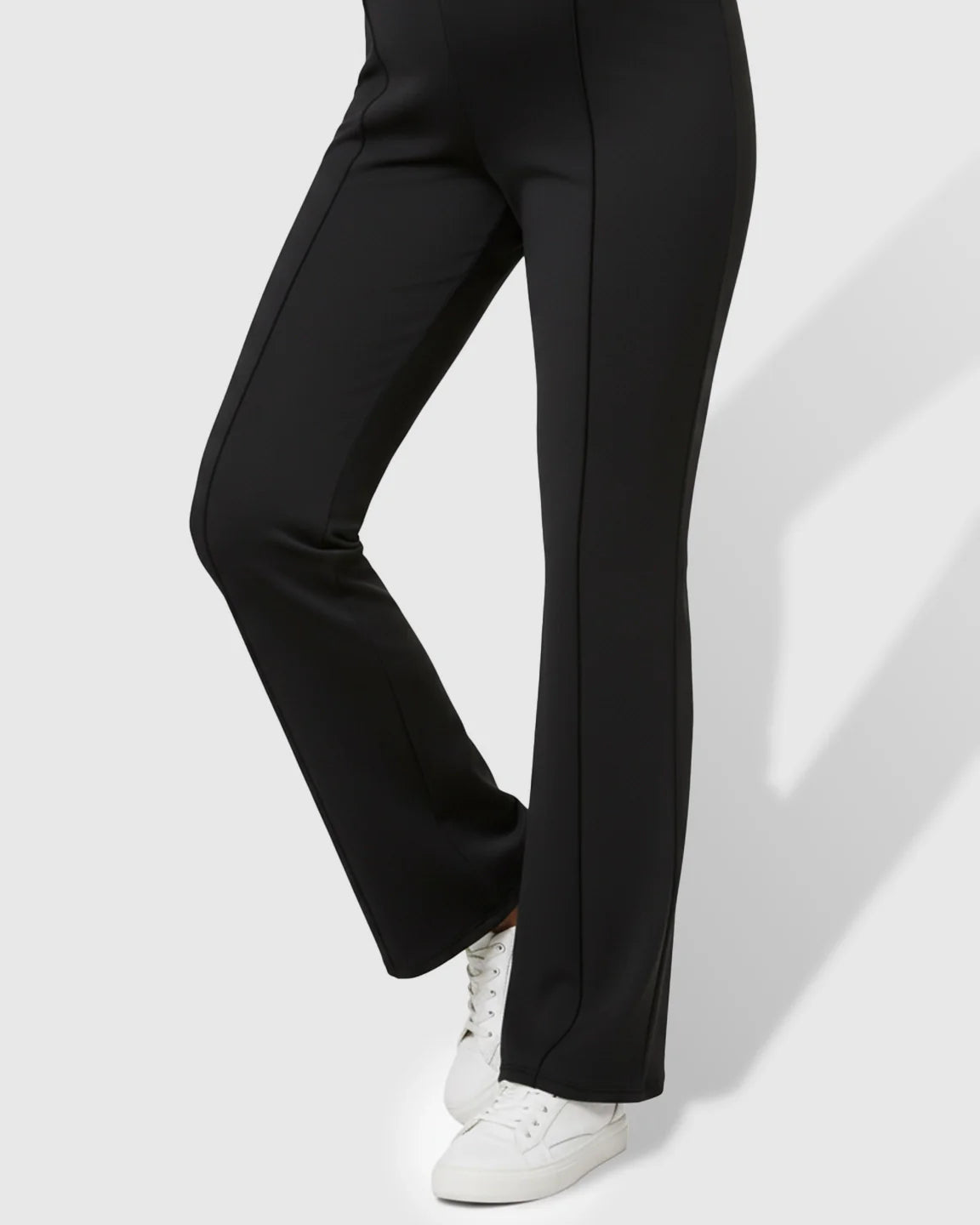 Black butt-lifting flared maternity pants with a high over-belly fit, vertical seams, and a buttery-soft stretch fabric.