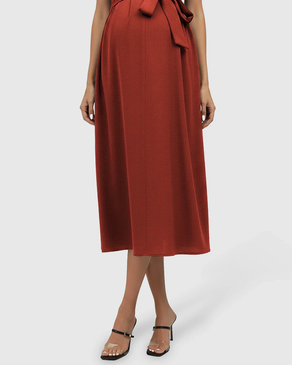 Rust red tie-waist V-neck maternity midi dress with flutter sleeves, flowing over the bump.