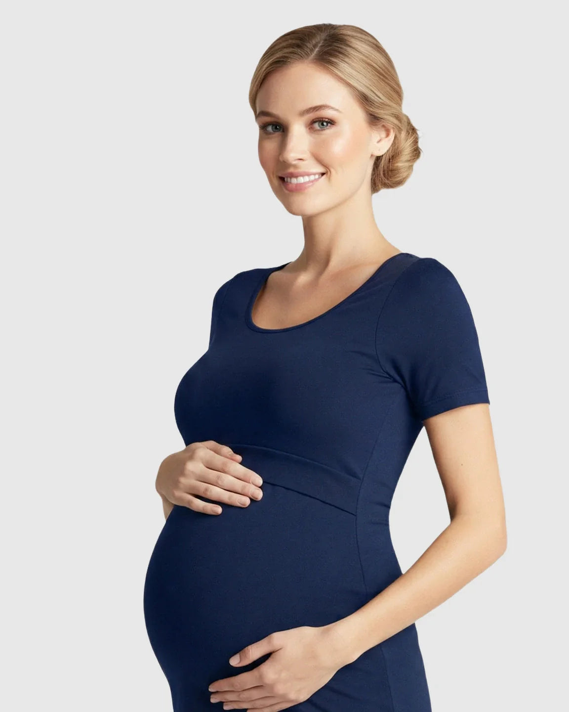 Smiling pregnant woman in a navy stretch-fit scoop-neck nursing t-shirt, cradling her belly.