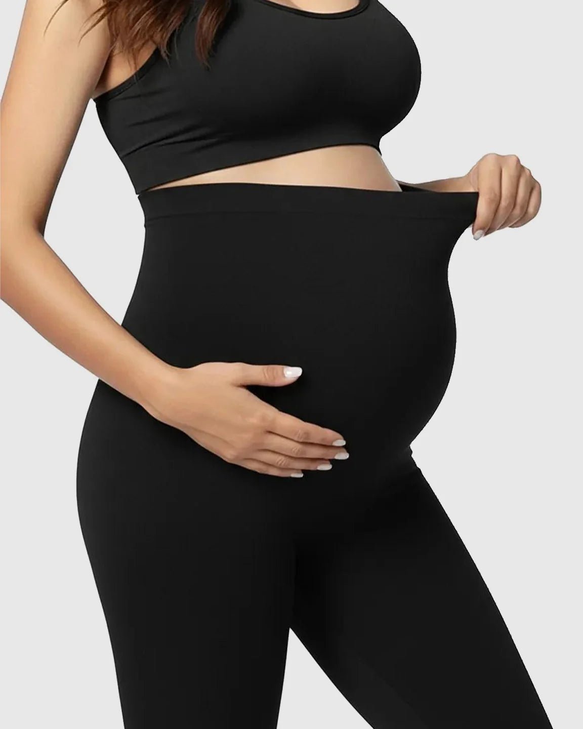 Pregnant woman in black Bump Society Belly Support Stretch Maternity Leggings, highlighting the high-waist panel.