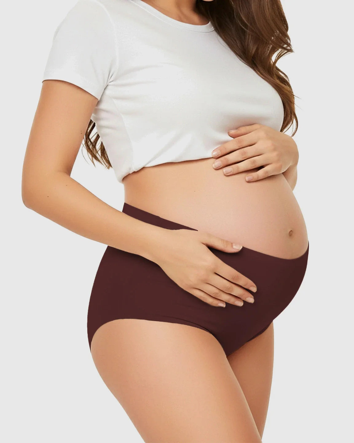 Pregnant woman wearing seamless high-waist support maternity underwear in a deep maroon color.