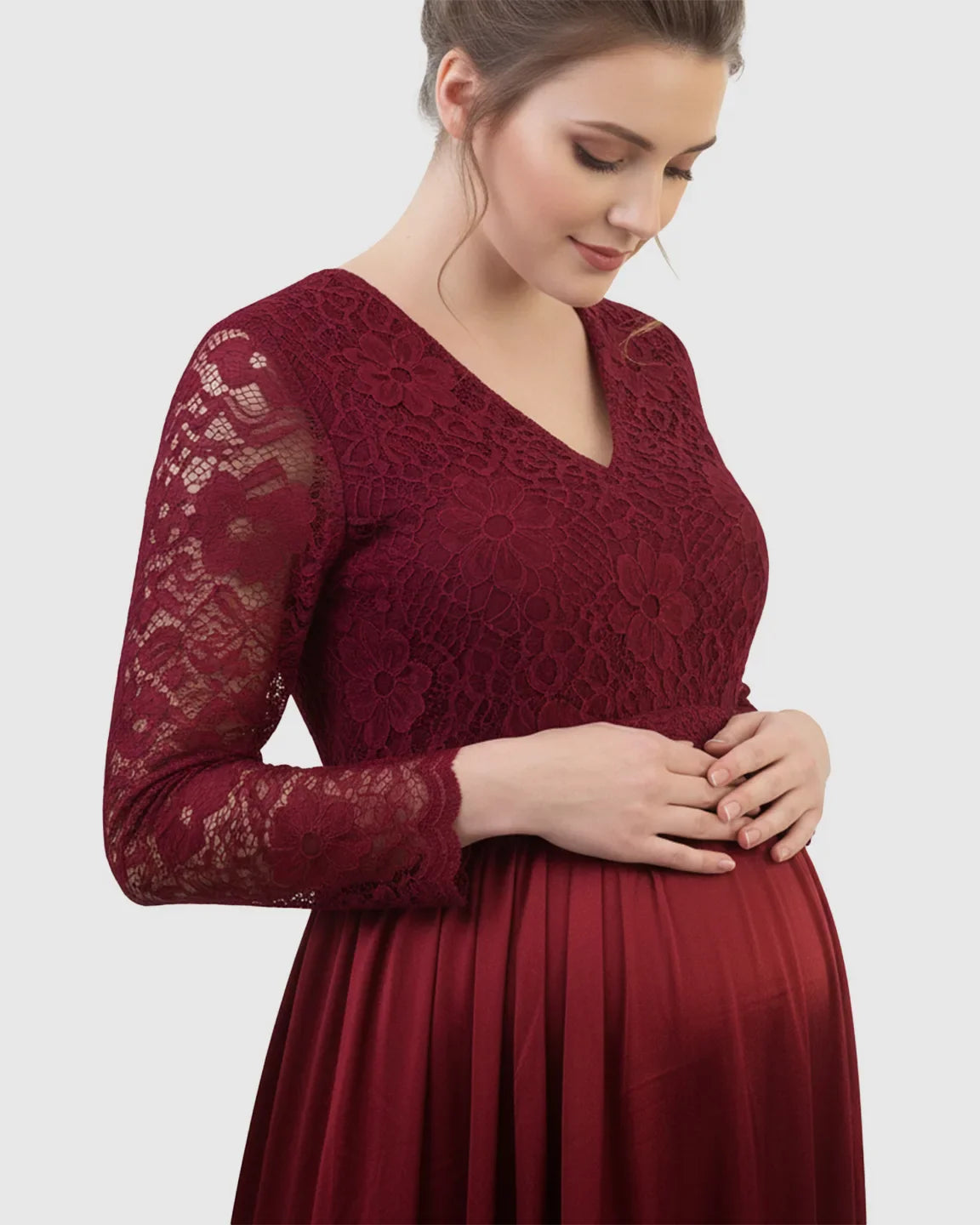 Burgundy lace-spliced bodice maternity maxi dress with V-neck and trailing skirt, worn by a pregnant woman.