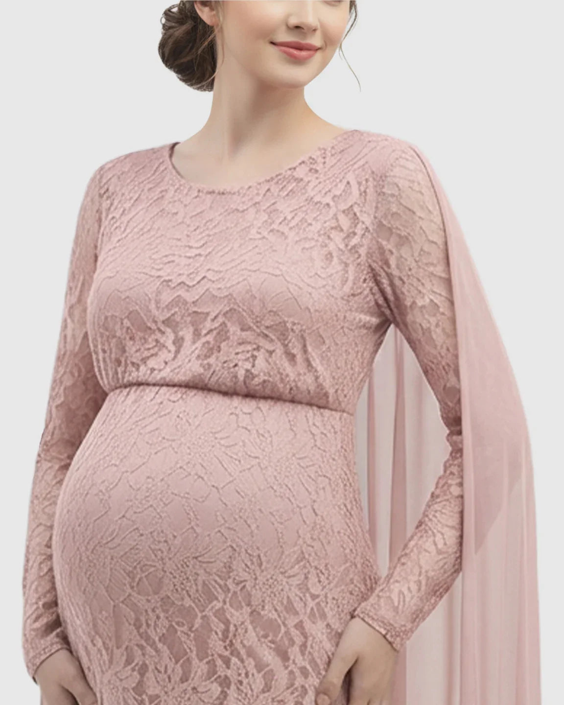 Pink lace long-sleeve maternity gown with an empire waist and flowing chiffon cape trailing.