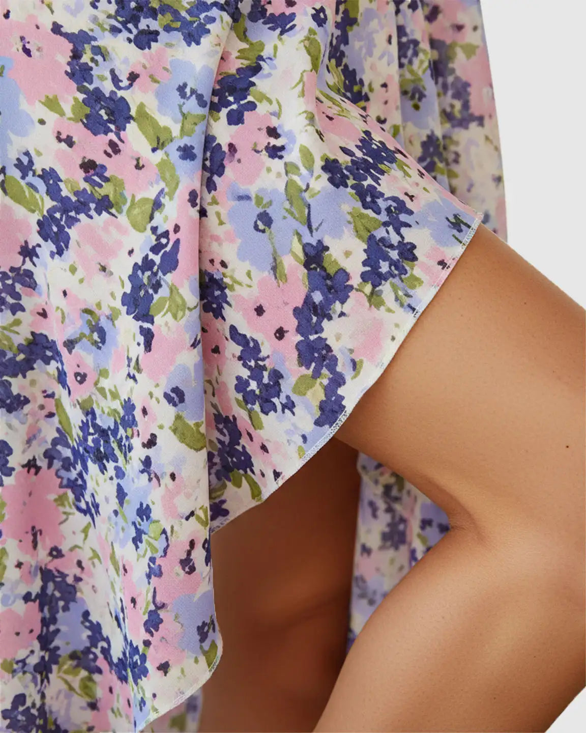 Close-up of a V-neck wrap-style floral maternity midi dress with pink, blue, and green flowers.
