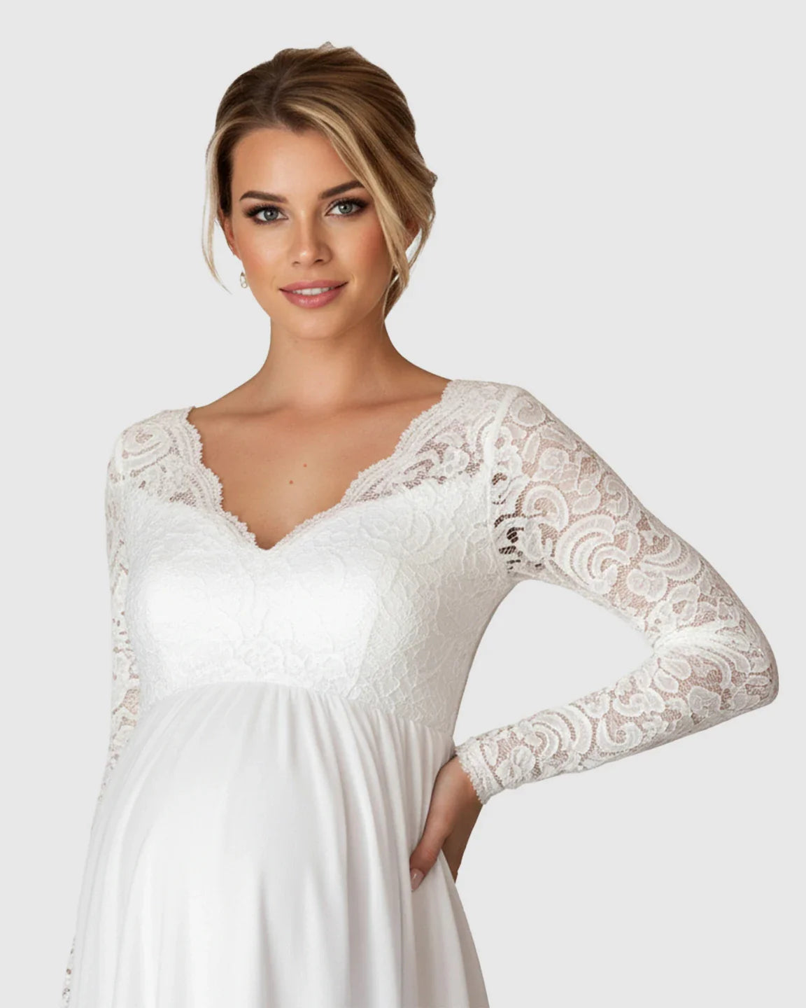 White lace maternity bridal gown with V-neck, long sleeves, and flowing skirt on a smiling woman.