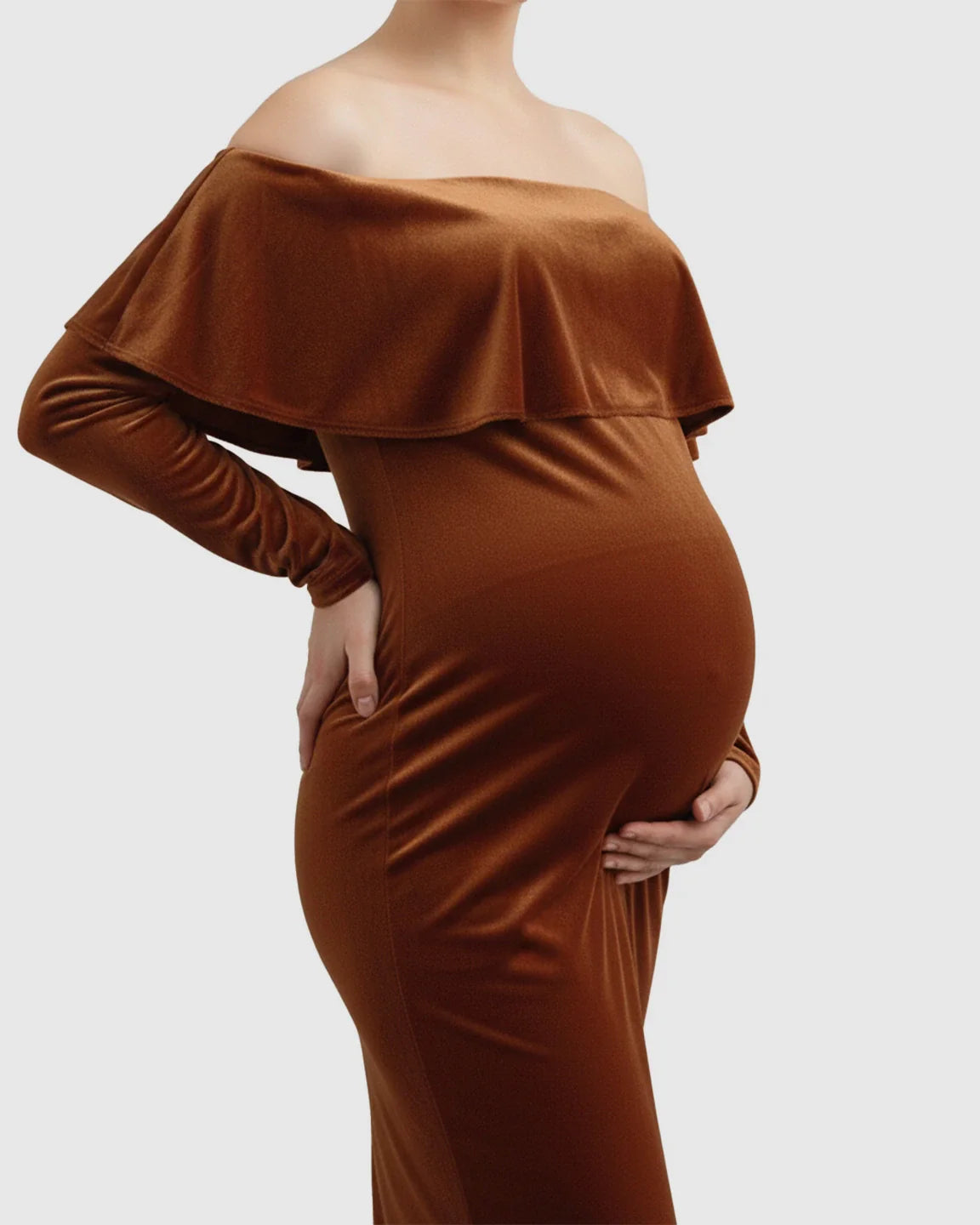 Velvet-touch elegant fitted maternity photoshoot gown in rich brown, off-shoulder with a ruffled bodice.