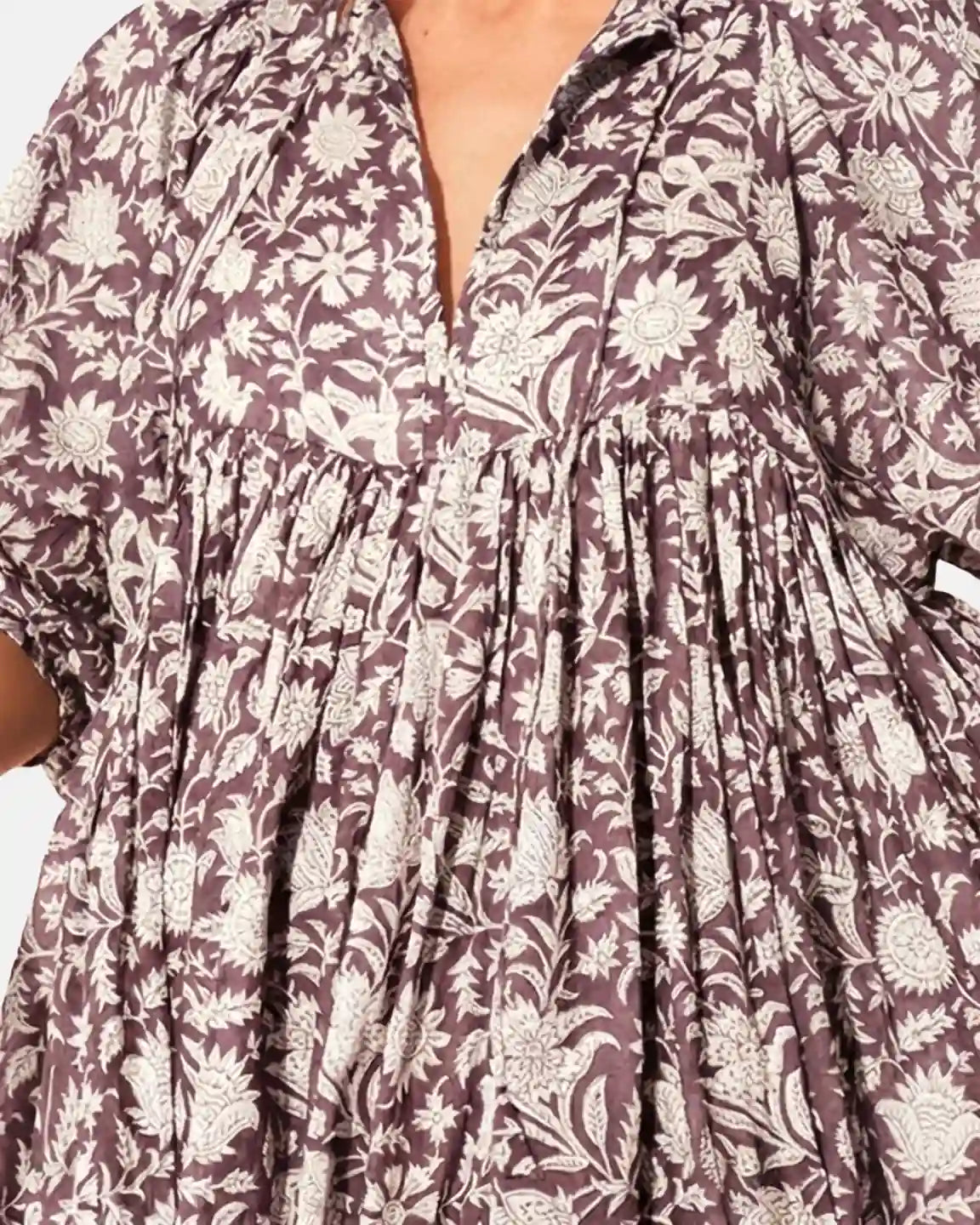 Loose fit maternity midi dress in brown and white floral print with gathered shoulders and V-neck.