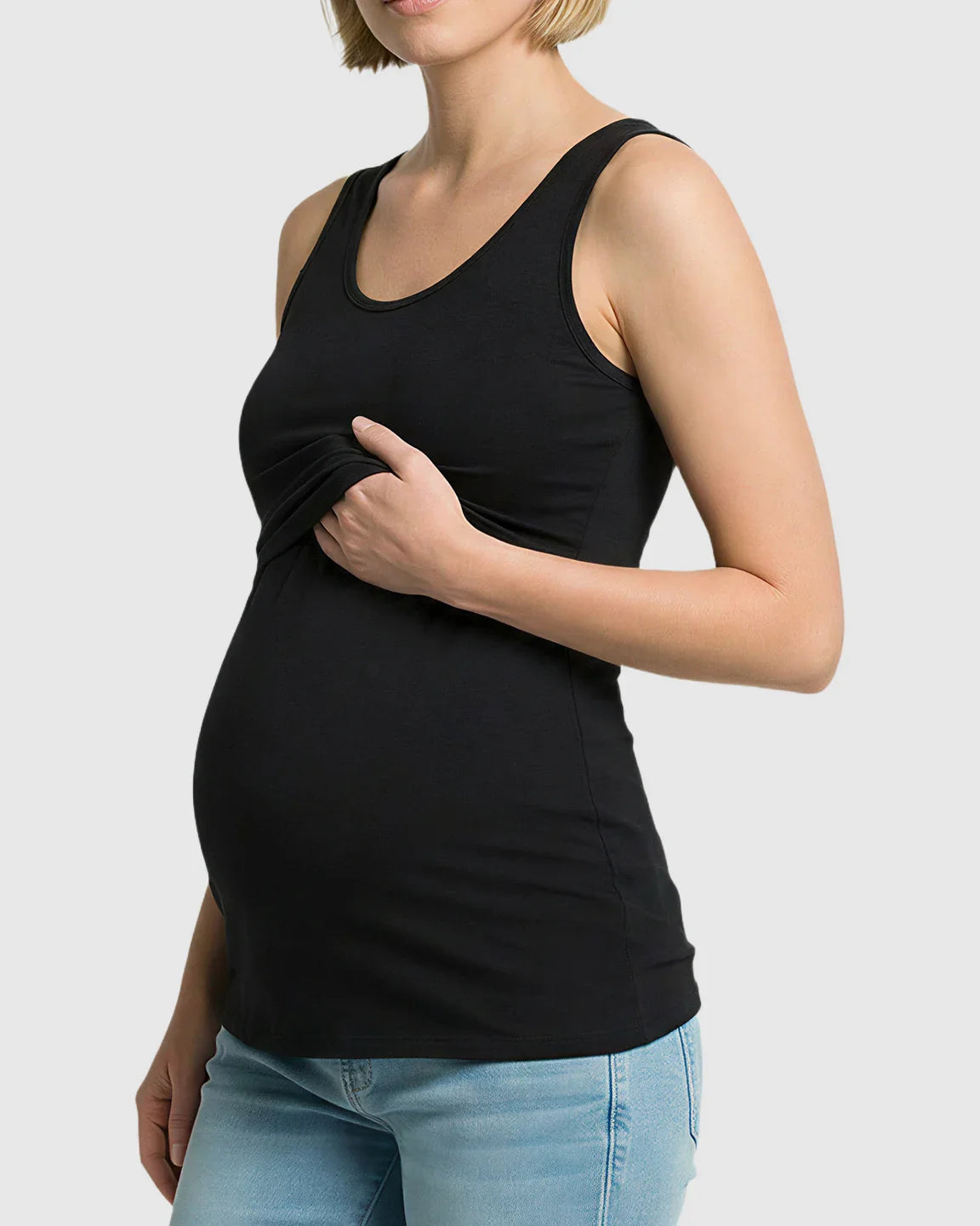 Pregnant woman in black stretch nursing-access maternity tank top, showing discreet nursing access.