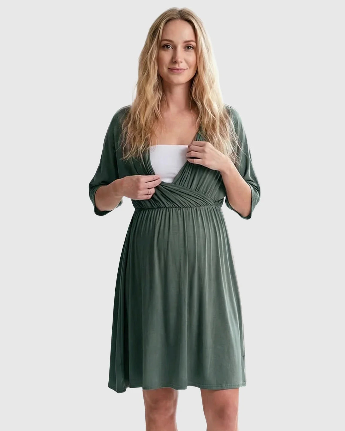 Blonde woman in a green cross-front maternity midi dress with 3/4 sleeves, showing nursing access.