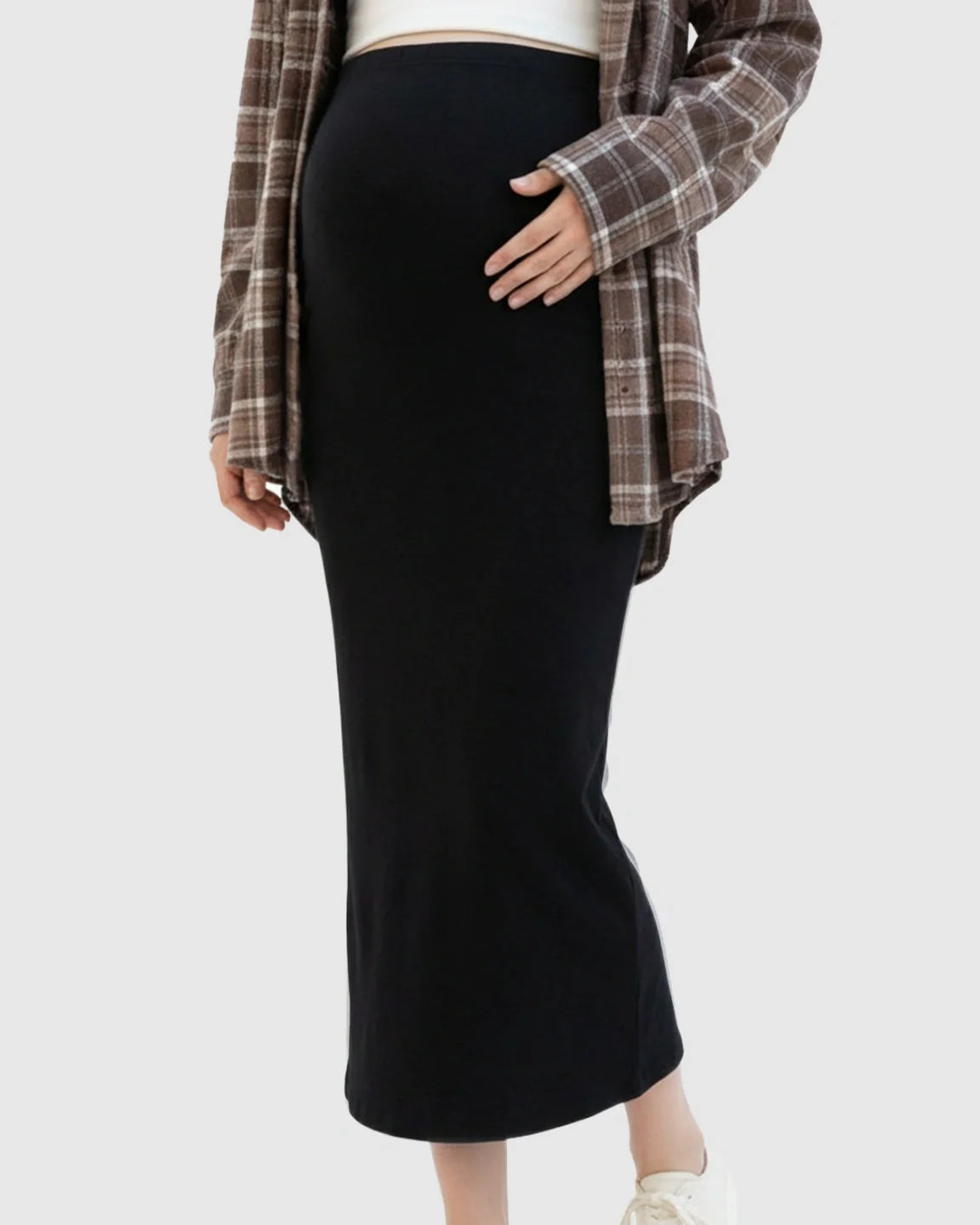 Black viscose blend maternity midi skirt with a relaxed fit, worn by a pregnant woman.