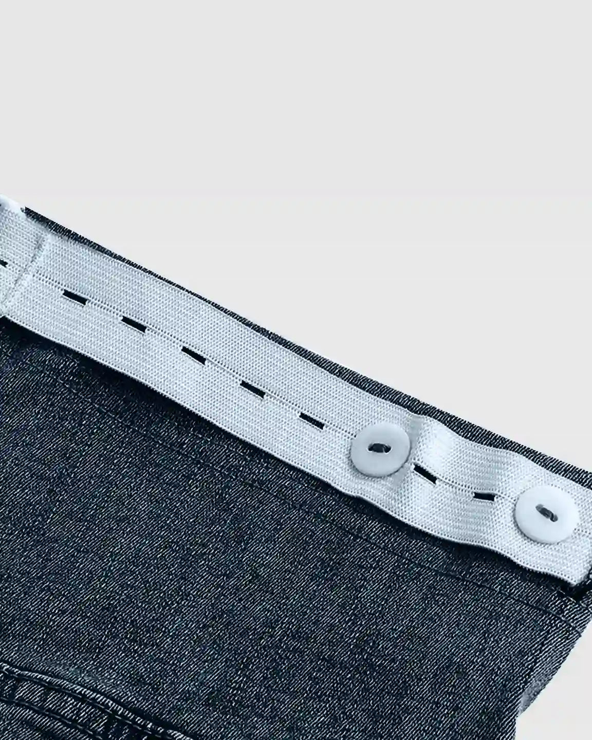 Dark wash stretch denim maternity jeans with adjustable white elastic waistband and buttons.