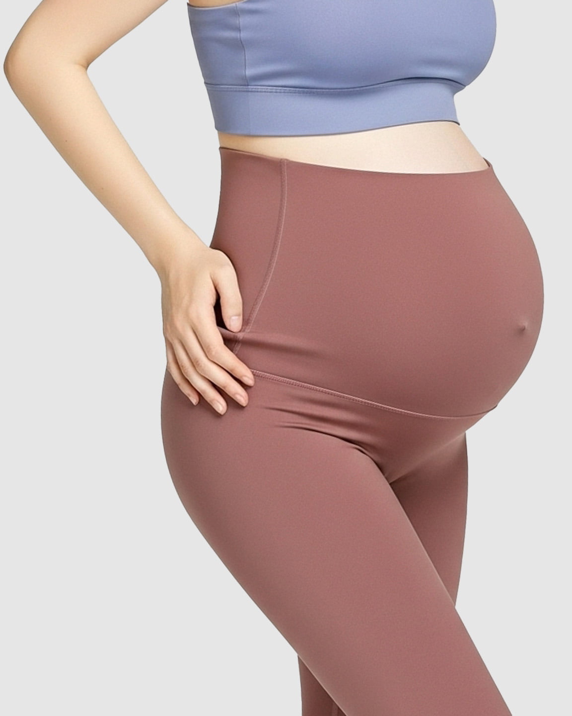Pregnant woman wearing high-waist, soft stretch maternity leggings in a dusty rose color.