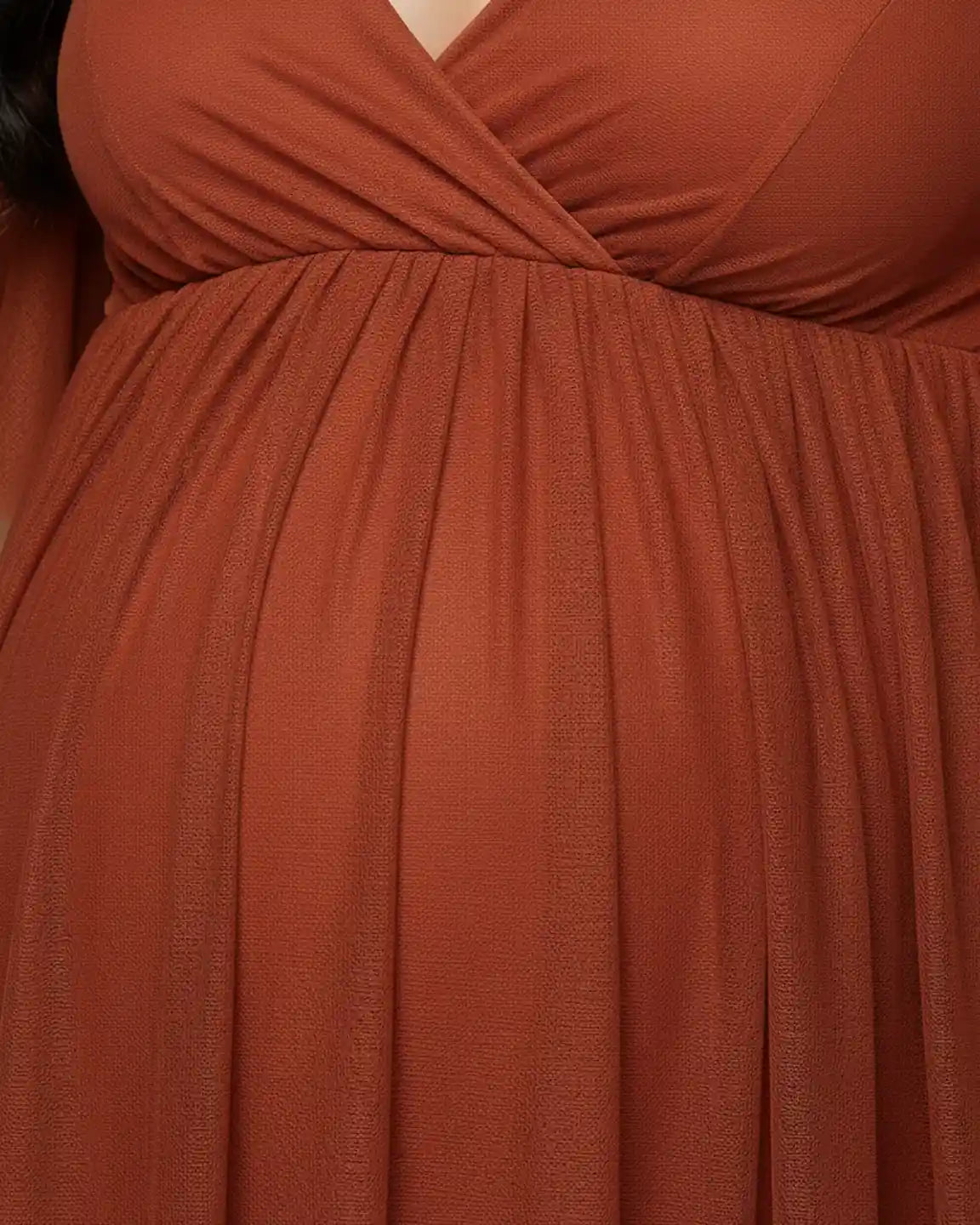 Rust chiffon V-neck empire waist maternity maxi dress, flowing over a pregnant belly.