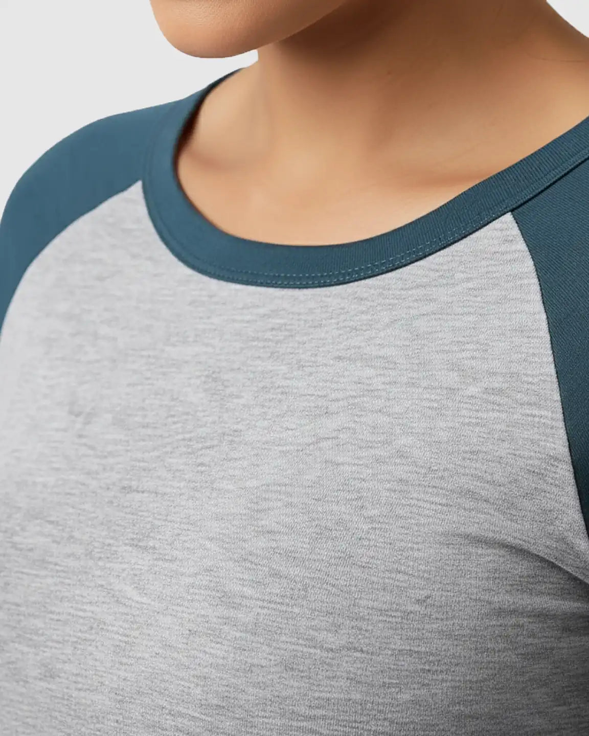 Gray and teal raglan sleeve maternity top with a round neck, made from soft, stretchy fabric.