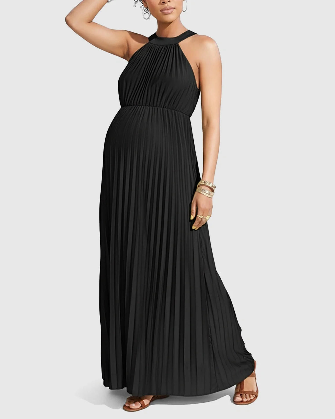 Black faux silk maternity maxi dress with a halter neck and elegant micro-pleats, flowing silhouette.