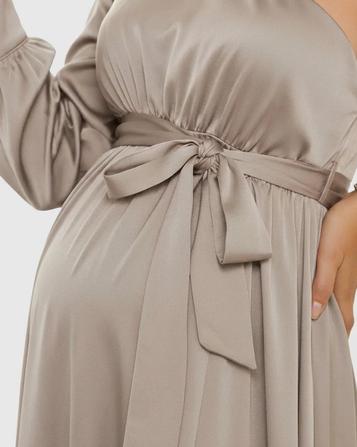 Elegant taupe satin maternity maxi dress with one-shoulder design, long sleeve, and tie-waist detail.