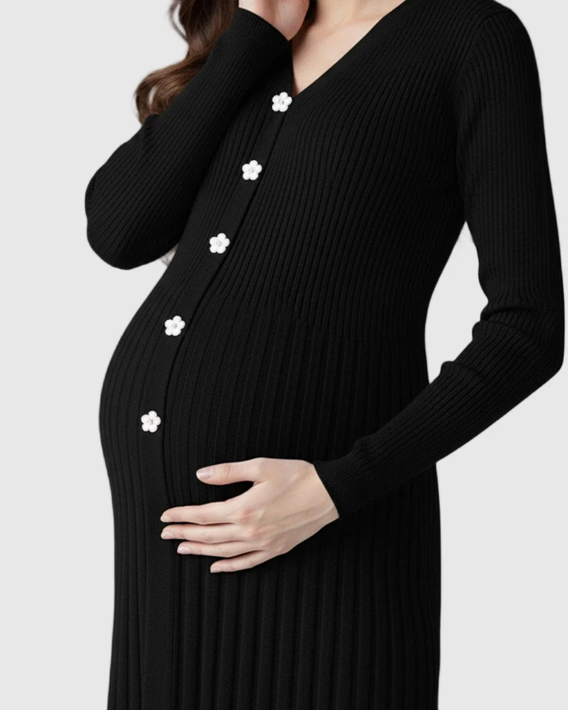 Black ribbed knit maternity midi dress with V-neck, long sleeves, and white floral buttons.