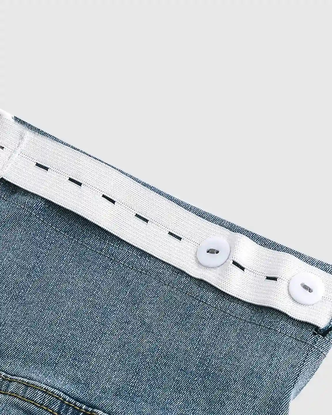 Light wash stretch denim maternity jeans with adjustable white elastic waistband and buttons.