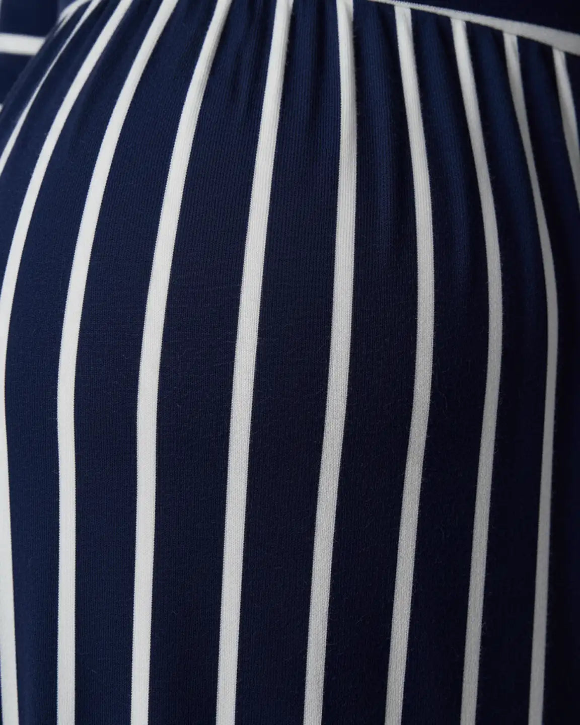 Close-up of a navy and white striped maternity maxi dress with soft stretch fabric.