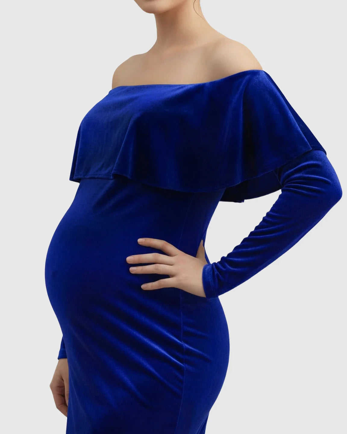 Velvet-touch royal blue off-shoulder maternity gown with long sleeves, fitted bodice, and elegant silhouette.