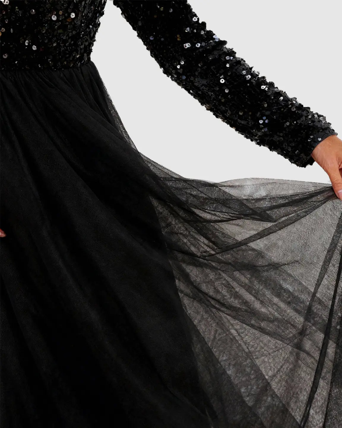 Black sequin long-sleeve empire waist maternity maxi dress with flowing mesh skirt.