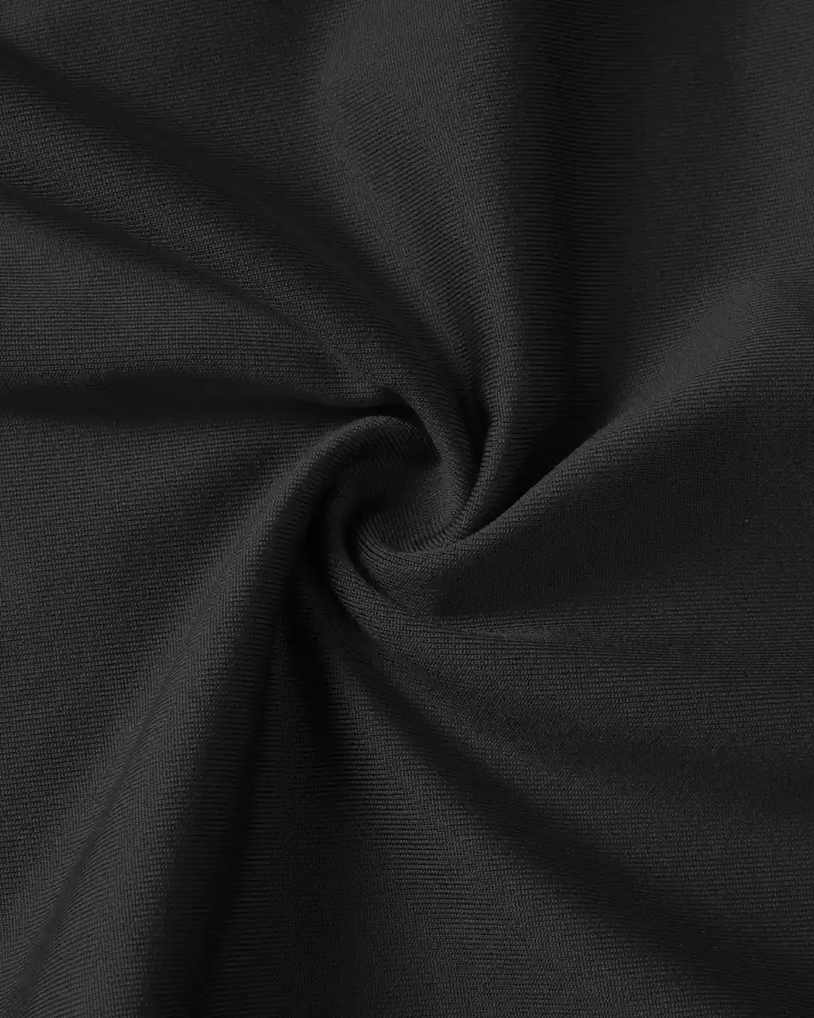 Close-up of black, stretchy, supportive slim-fitting maternity jogger fabric with a subtle texture.