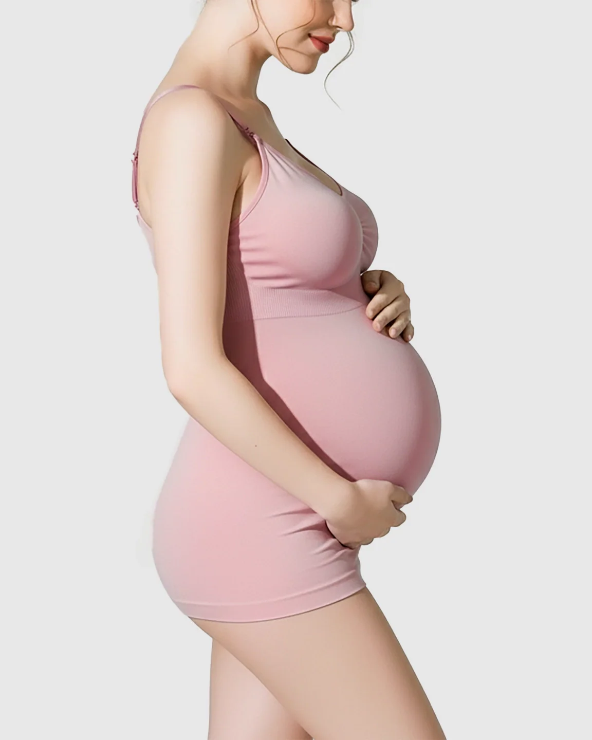 Pregnant woman in a pink soft stretch wireless maternity nursing bra and matching shorts.