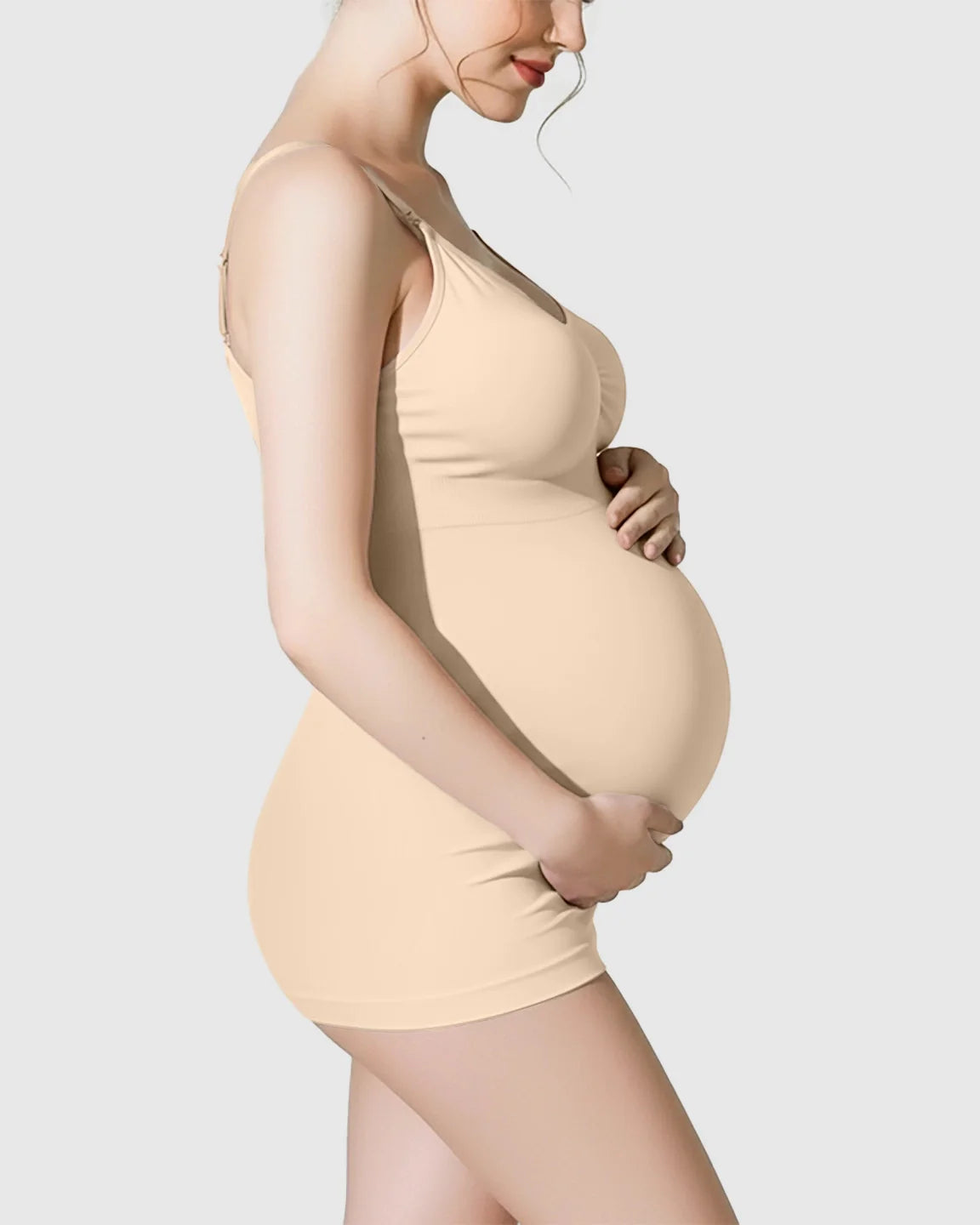 Pregnant woman in a nude soft stretch wireless maternity nursing camisole.