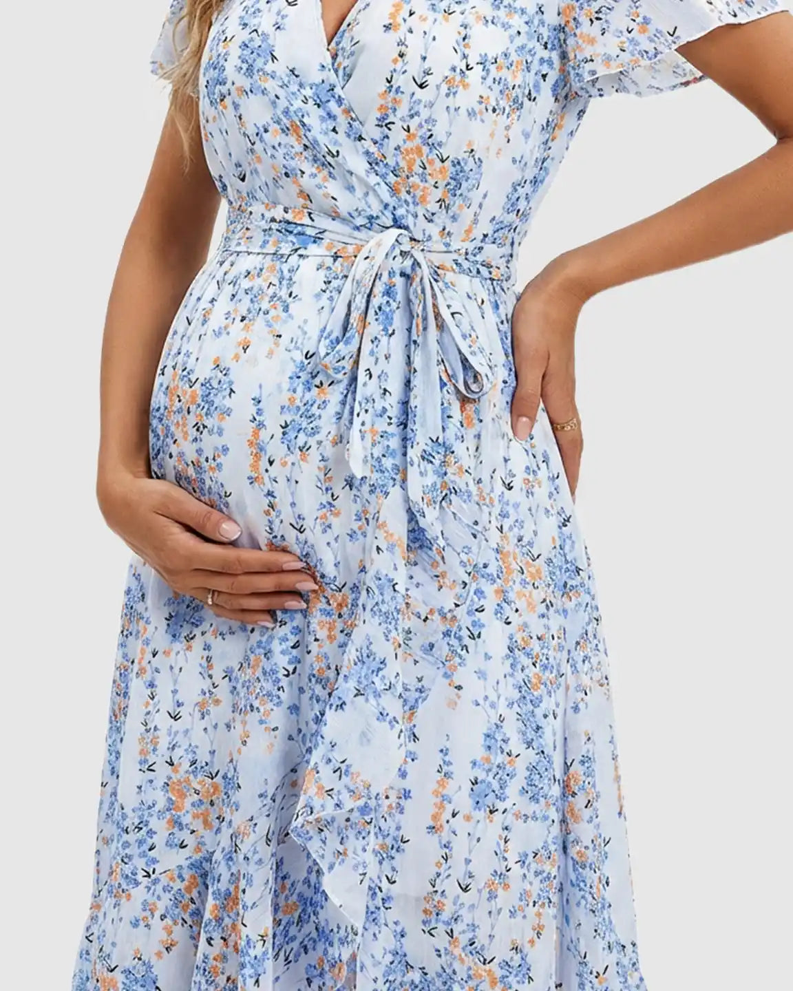 Maternity midi dress with blue and orange floral print, V-neck, waist tie, and ruffled hem.