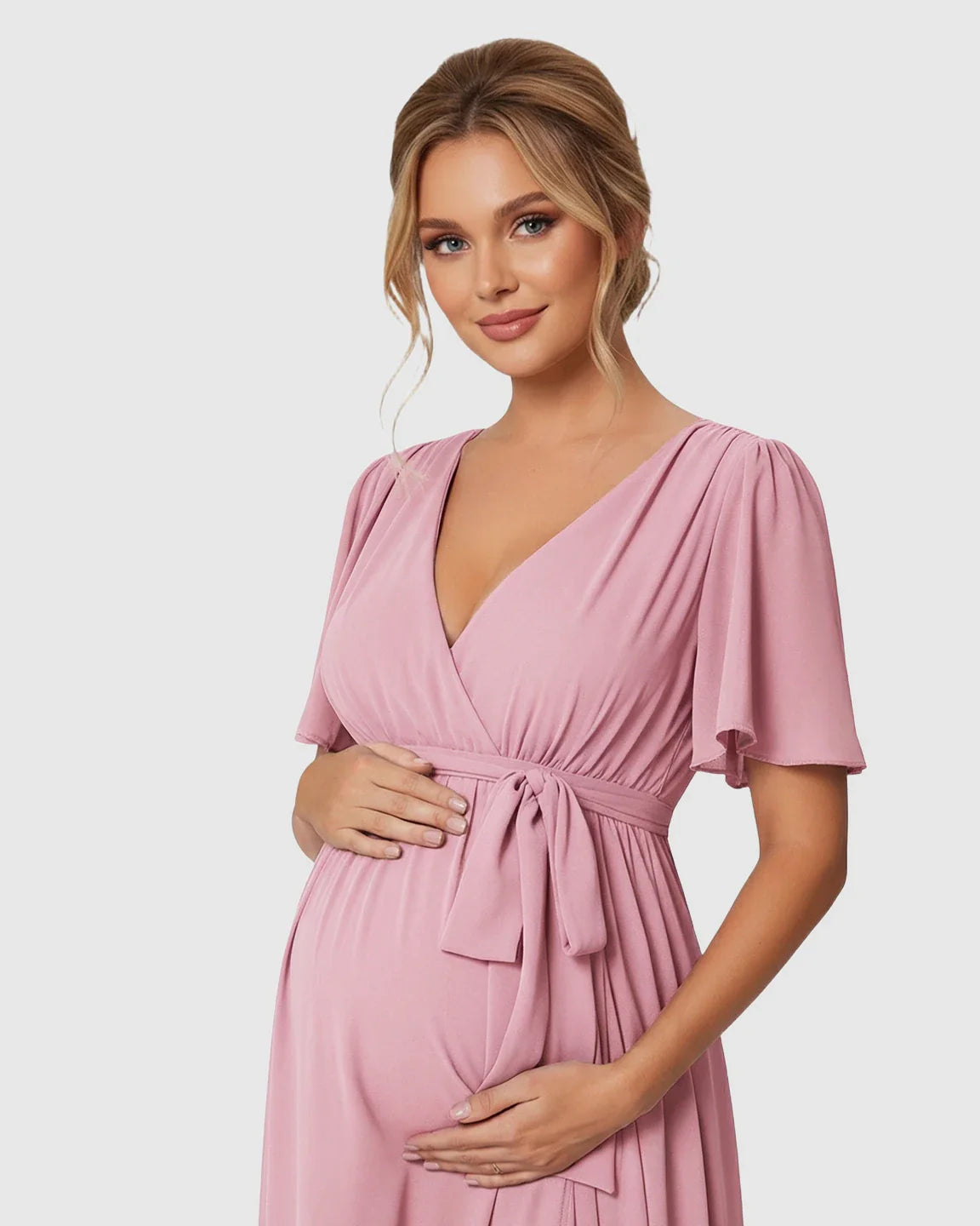 Pink surplice V-neck flutter sleeve maternity maxi dress with empire waist tie.
