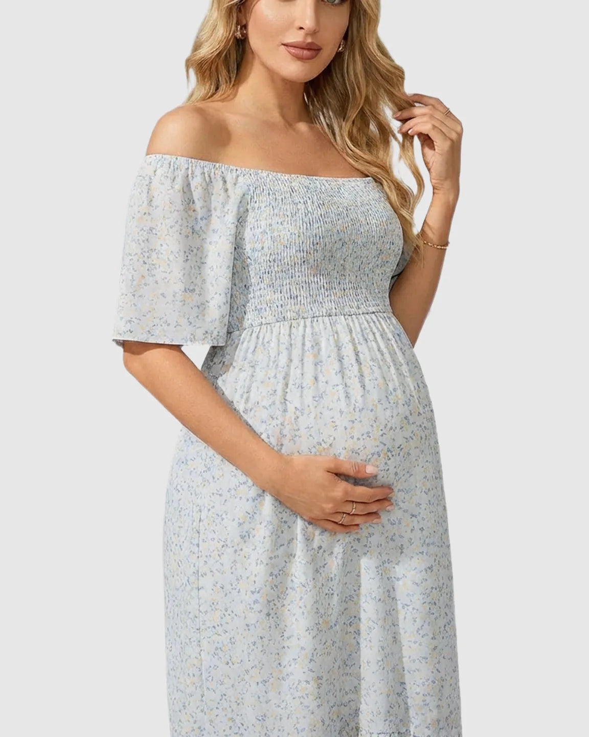 Light blue floral off-shoulder smocked maternity midi dress with flutter sleeves and flowy skirt.