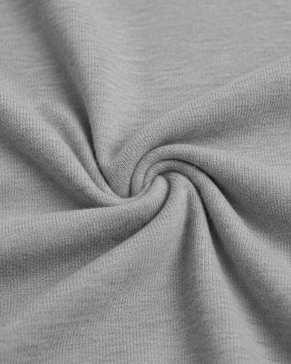 Close-up of soft, light gray polyester fabric, showing its stretchy texture and subtle weave.