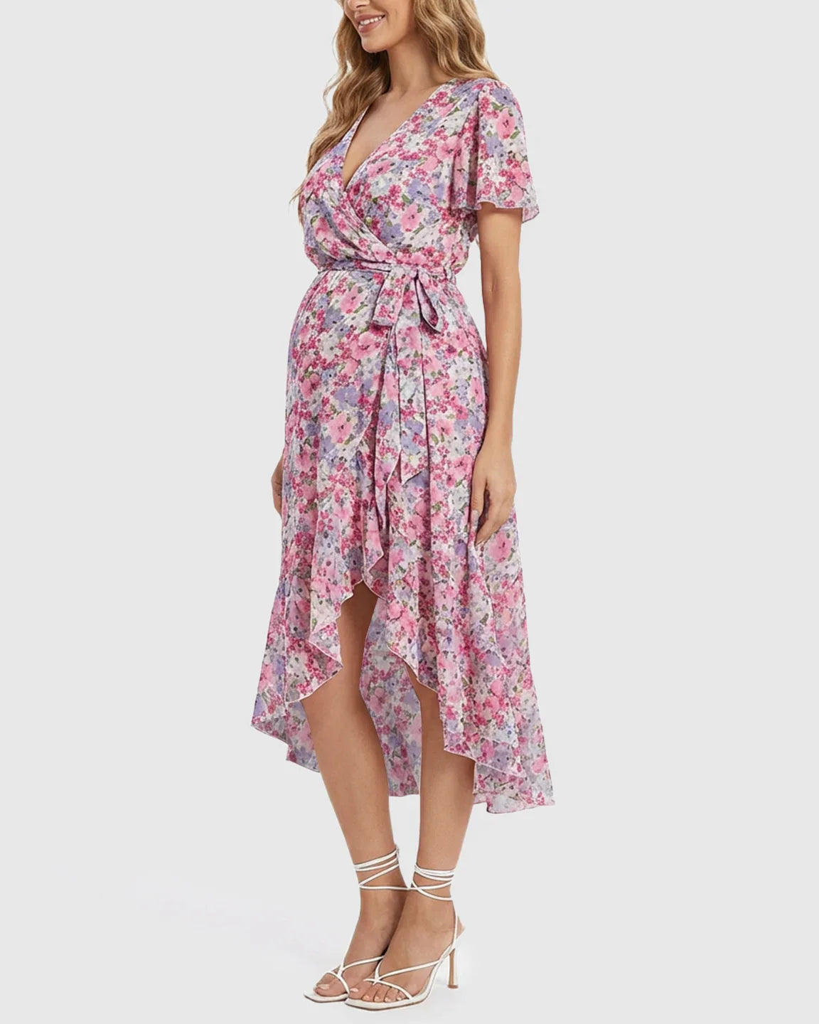 Floral V-neck ruffled hem maternity midi dress in pink and purple, with a wrap-style and tie waist.