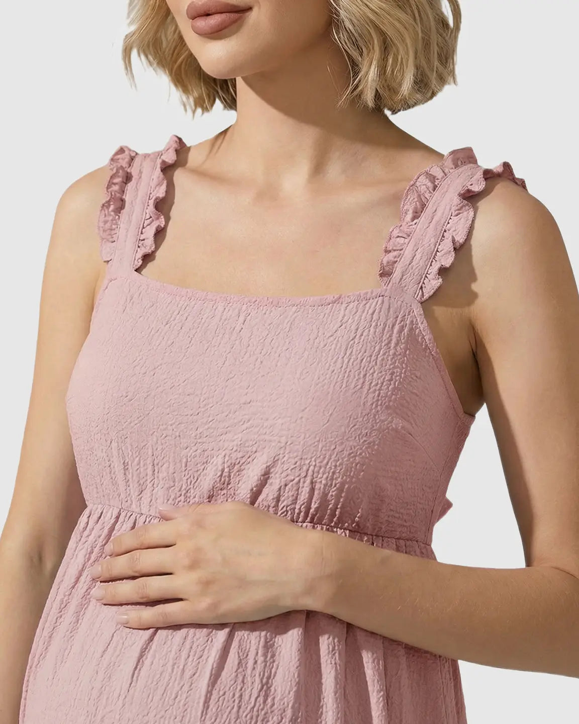 Pink ruffled strap maternity maxi dress with square neckline and textured fabric.