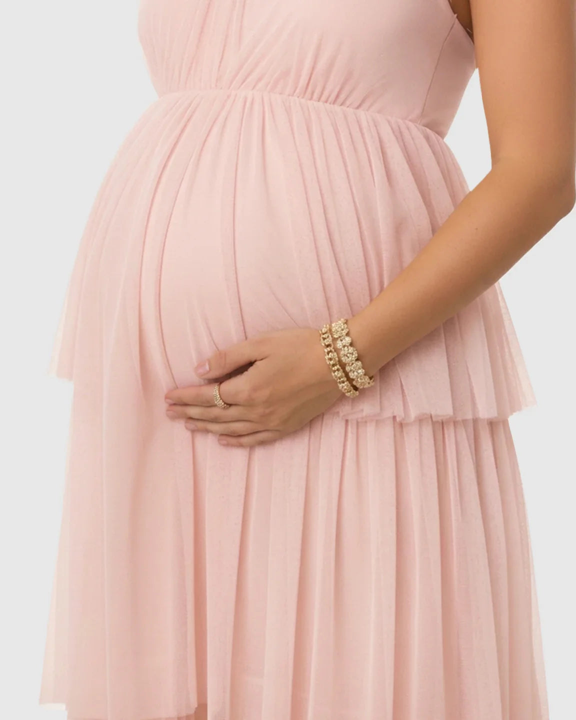 Pink halter neck tiered mesh maternity gown, flattering the bump with soft, flowing layers.