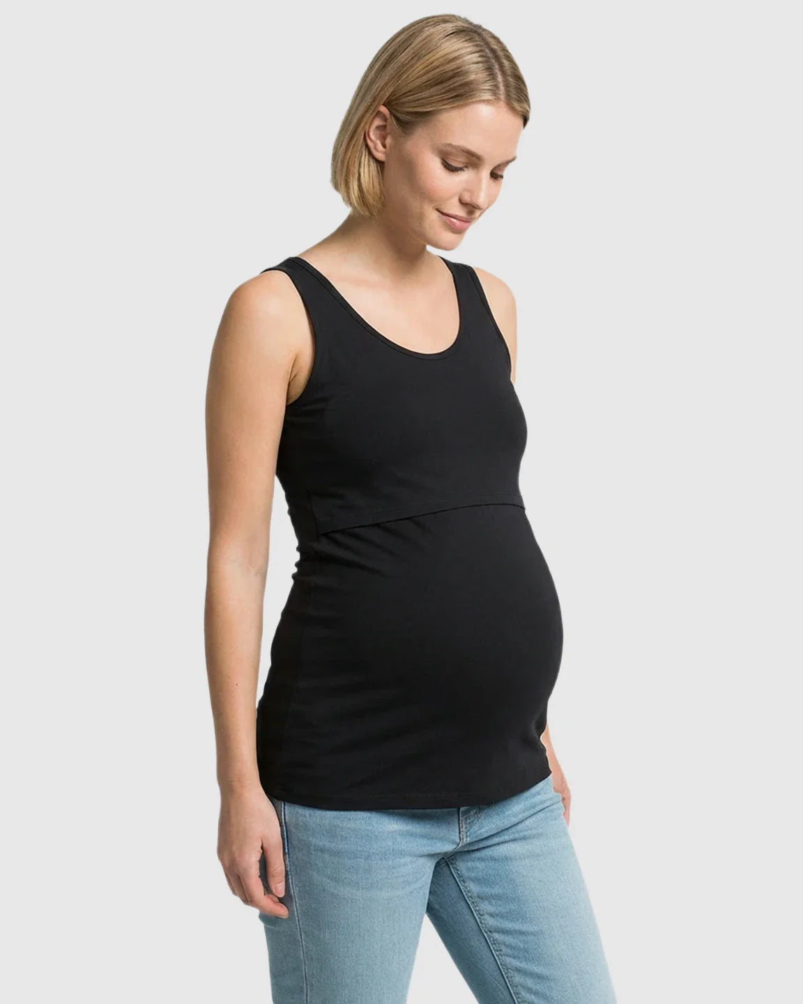Pregnant woman in a black stretch nursing-access maternity tank top and jeans.