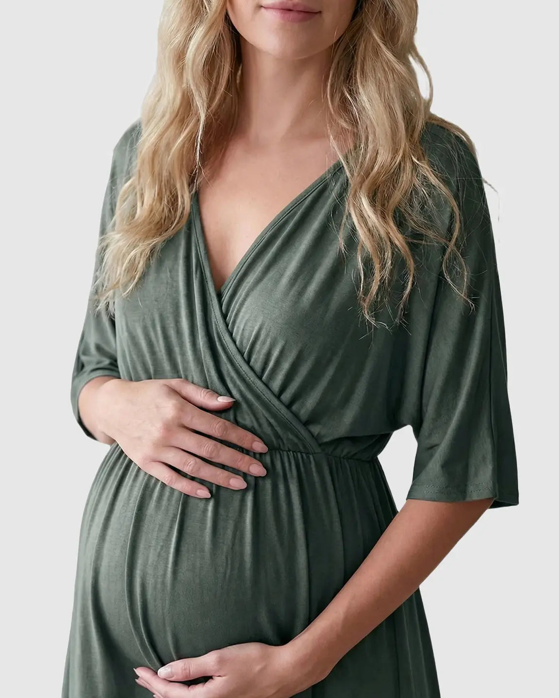 Maternity midi dress in olive green with a cross-front V-neck, 3/4 sleeves, and a flowy A-line silhouette.