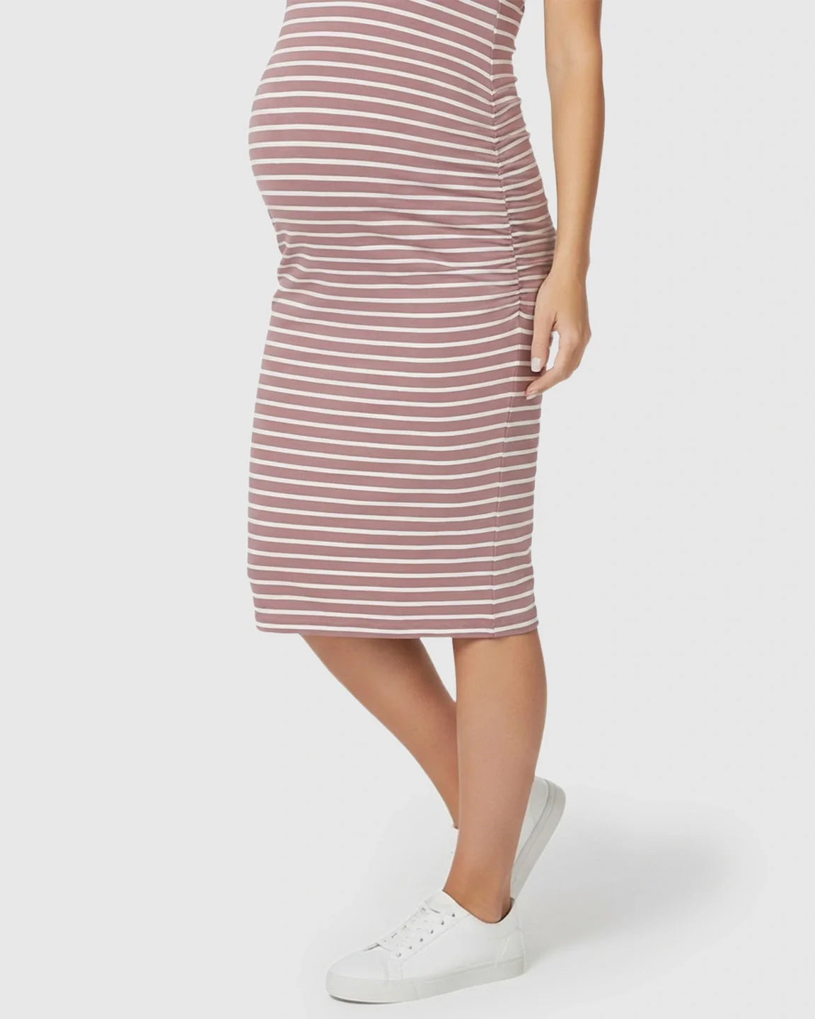 Sleeveless, dusty rose and white striped maternity bodycon dress with side pleats, worn with white sneakers.