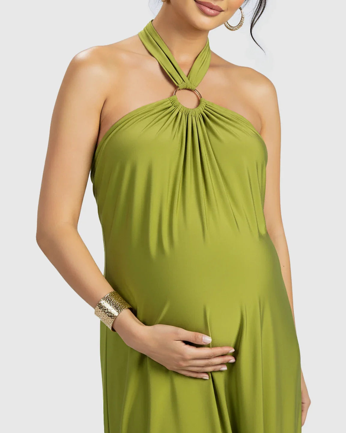 Maternity maxi dress in olive green chiffon, featuring a backless halter neck with a gold ring detail.
