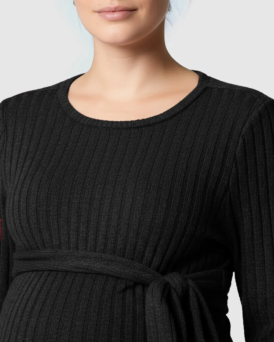 Black ribbed maternity sweater with a tie-waist and long sleeves, featuring a round neckline.