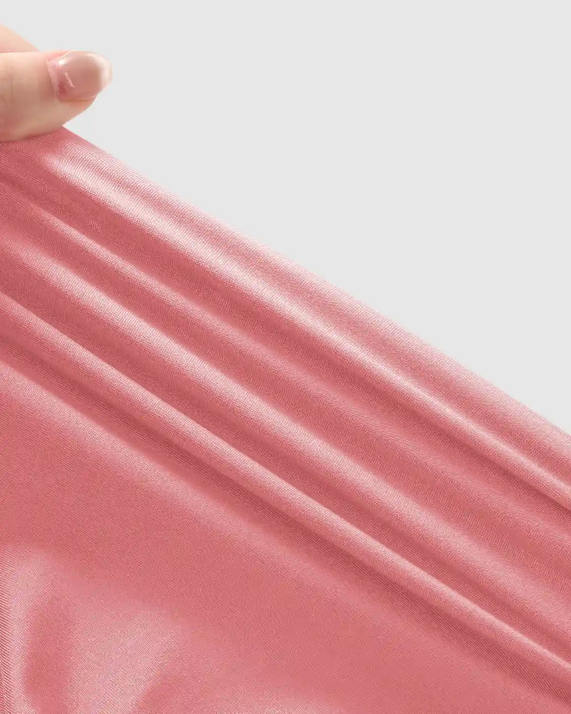 Close-up of soft, stretchy pink fabric, highlighting the gentle texture and flexible material of maternity joggers.