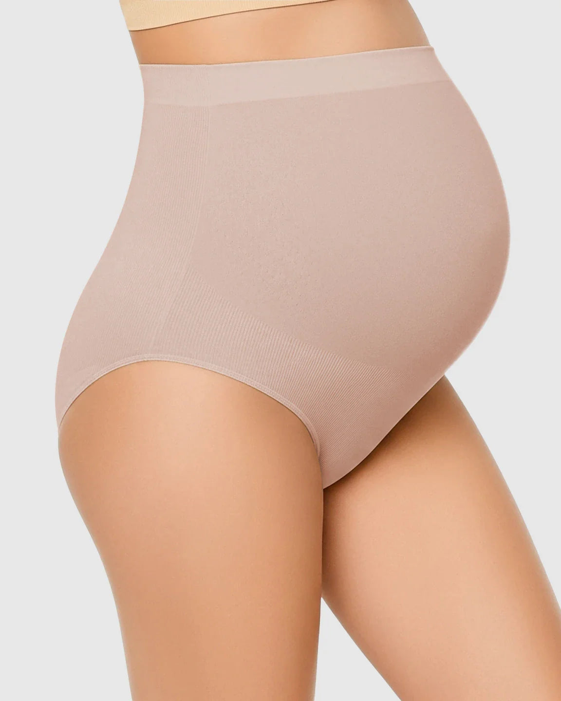 Nude high-waist seamless maternity underwear on a pregnant model, offering gentle belly support.