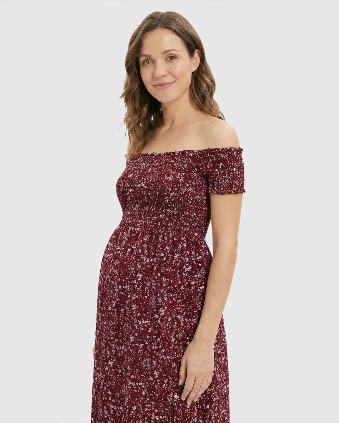 Maternity maxi dress: red floral print, off-shoulder, smocked bodice, side slit, cotton-poly blend.